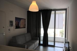 a living room with a couch and a large window at Appartamenti porta mare in Otranto
