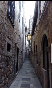 an alley with a street light on the side of a building at Rilati Old town Palace 1 in Dubrovnik