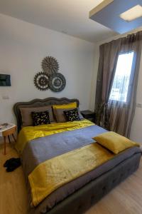 a bedroom with a large bed with a yellow blanket at A casa di V-Ale in Treviso