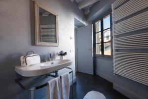a bathroom with a sink and a window at Isola Bella Apartments - Via del Voltone in Stresa