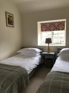 Postel nebo postele na pokoji v ubytování Mabel's Cottage