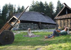 a group of people sitting in the grass in front of a building at Seaview apartment Karmøy in Sæveland