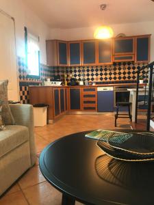 a living room with a table and a kitchen at Seafront Maisonette in Pefkochori