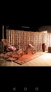 two chairs and a rug in front of a curtain at El Sabinar in Vallehermoso