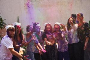 a group of people covered in holi paint at The Desire Hostel in New Delhi