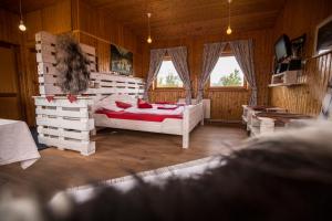 a bedroom with a bed in a room with wooden walls at Hestasport Cottages in Varmahlid
