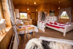 a bedroom with a bed and a dog in a room at Hestasport Cottages in Varmahlid