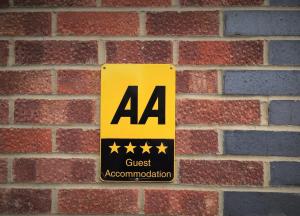 a sign on a brick wall with four stars at The PitStop in Bishops Stortford