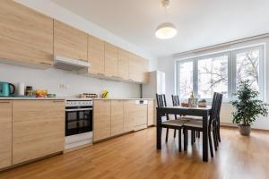 a kitchen with a table and chairs in a kitchen at Spacious Apartment in the Old Town of Bratislava in Bratislava