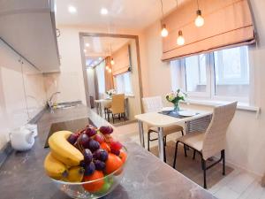 a bowl of fruit on a counter in a kitchen at Apartment on Potanina 16 in Ustʼ-Kamenogorsk