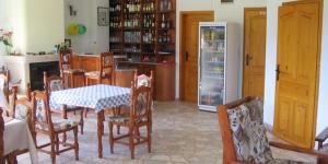 a kitchen with a table and chairs and a refrigerator at Victoria Sinemorets Guest House in Sinemorets
