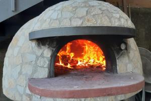 a stone oven with a fire in it at Il Profumo di Capri in Massa Lubrense