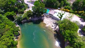 an aerial view of a river with a bridge at Hotel Nututun Palenque in Palenque