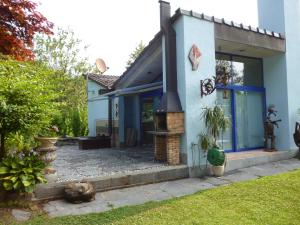 ein blaues Haus mit einem Kamin im Hof in der Unterkunft Casa Aline in Contra
