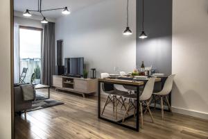 a living room with a dining room table with chairs at MyCherry - Old Town Apartment - Księcia Witolda 11 in Wrocław