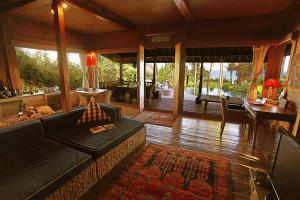 a living room with a couch and a table at Sejuk Beach Villas in Canggu