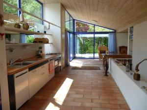 a kitchen with a large window and a large floor to ceiling glass door at Casa Aline in Contra