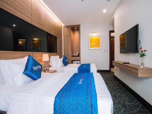 En eller flere senger på et rom på Spring Hotel Hanoi