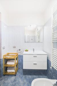 a bathroom with a white sink and a toilet at Anagnina Apartment in La Romanina