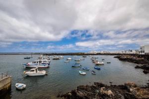 a group of boats are docked in a harbor at Apartamento Salinas del Mar in Orzola