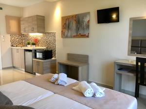a kitchen with white towels on a table in a room at Roula Kotsonis Superior Apartment in Argassi