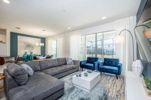a living room with a couch and two blue chairs at Varios Resort Pool Homes in Davenport