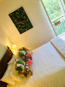 a bedroom with a bed with stuffed animals on it at Villa Bacchetta - Garden View in Oleggio Castello