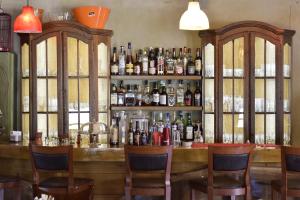a bar with a lot of bottles of alcohol at Great Mantineia in Levidi
