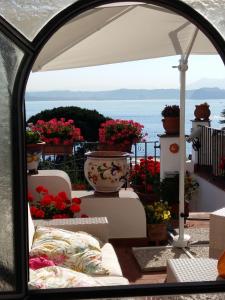 a view from a window of a balcony with flowers at b&b Dea Fortuna in Bacoli
