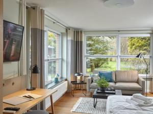 a living room with a couch and a table at Düne 6 in Sankt Peter-Ording