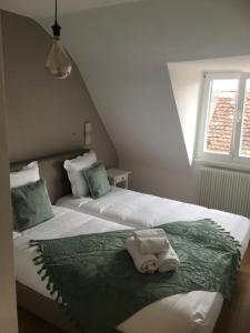 a bedroom with two beds with towels on them at Les Appartements de Home Petite Venise in Colmar