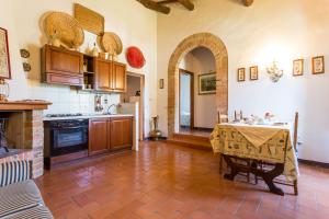 a kitchen with a table with a table cloth on it at Tenuta Di Argiano A Montepulciano in Chianciano Terme