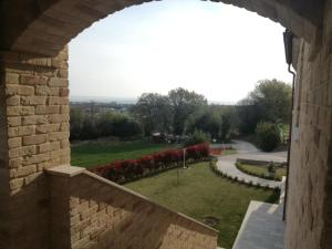 a view of a garden from an archway in a building at B&B CasalFarano in Cupra Marittima