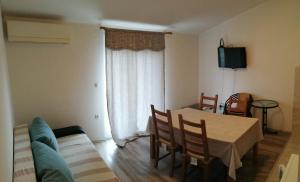 a living room with a table and a couch at Apartments Sadina in Skradin