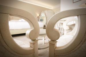 a bedroom with a bed and a large mirror at Hotel Villa Margherita in Quercianella +37 photos
