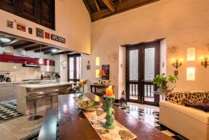 a kitchen and living room with a table and a couch at Casa San Pedro - Exclusive 3BR Colonial Apt in Centro Historico by Huespedia in Cartagena de Indias