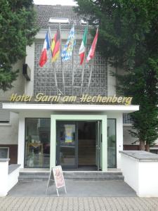 a building with different flags in front of it at Hotel Garni am Hechenberg in Mainz