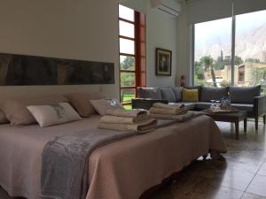 a bedroom with a bed with towels on it at Zen Home & Garden House in Cieneguilla +41 photos