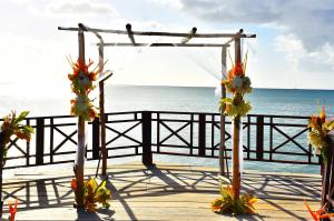 an altar on the beach with the ocean in the background at Calabash Cove Resort and Spa - Adults Only in Gros Islet
