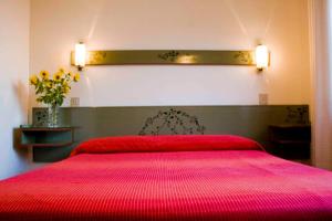Postel nebo postele na pokoji v ubytování Hotel Kennedy