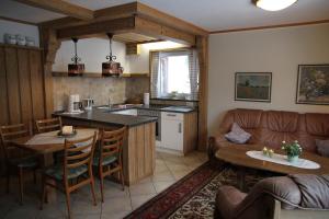 a kitchen and living room with a couch and a table at Ferienwohnung Bücker in Schmallenberg