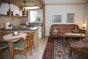 eine Küche und ein Wohnzimmer mit einem Sofa und einem Tisch in der Unterkunft Ferienwohnung Bücker in Schmallenberg