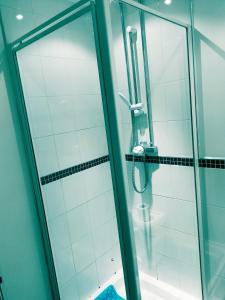 a shower in a bathroom with a glass door at Longford Street, Derby in Derby
