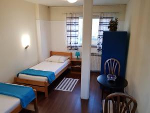 札格雷布的住宿－法維拉旅館，小房间设有两张床和窗户