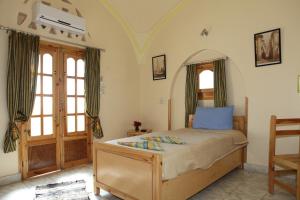 Postel nebo postele na pokoji v ubytování El Fayrouz Hotel