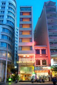 two tall buildings in a city at night at Lien An Sai Gon Hotel in Ho Chi Minh City