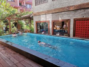 a group of people swimming in a swimming pool at Hotel Middle Path & Spa in Pokhara