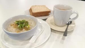 a table with a bowl of soup and a cup of coffee at Duangdren Apartment in Chiang Mai