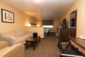 a hotel room with a couch and a bed at Best Western Sawtooth Inn and Suites in Jerome