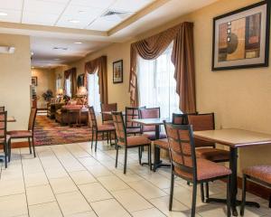 a waiting room with tables and chairs and a couch at Quality Inn Near Interstate I94 in New Buffalo